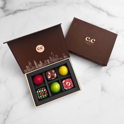 6-piece Christmas CbyC Chocolate Ganache Box with hand-crafted round chocolates, elegantly presented in a brown.